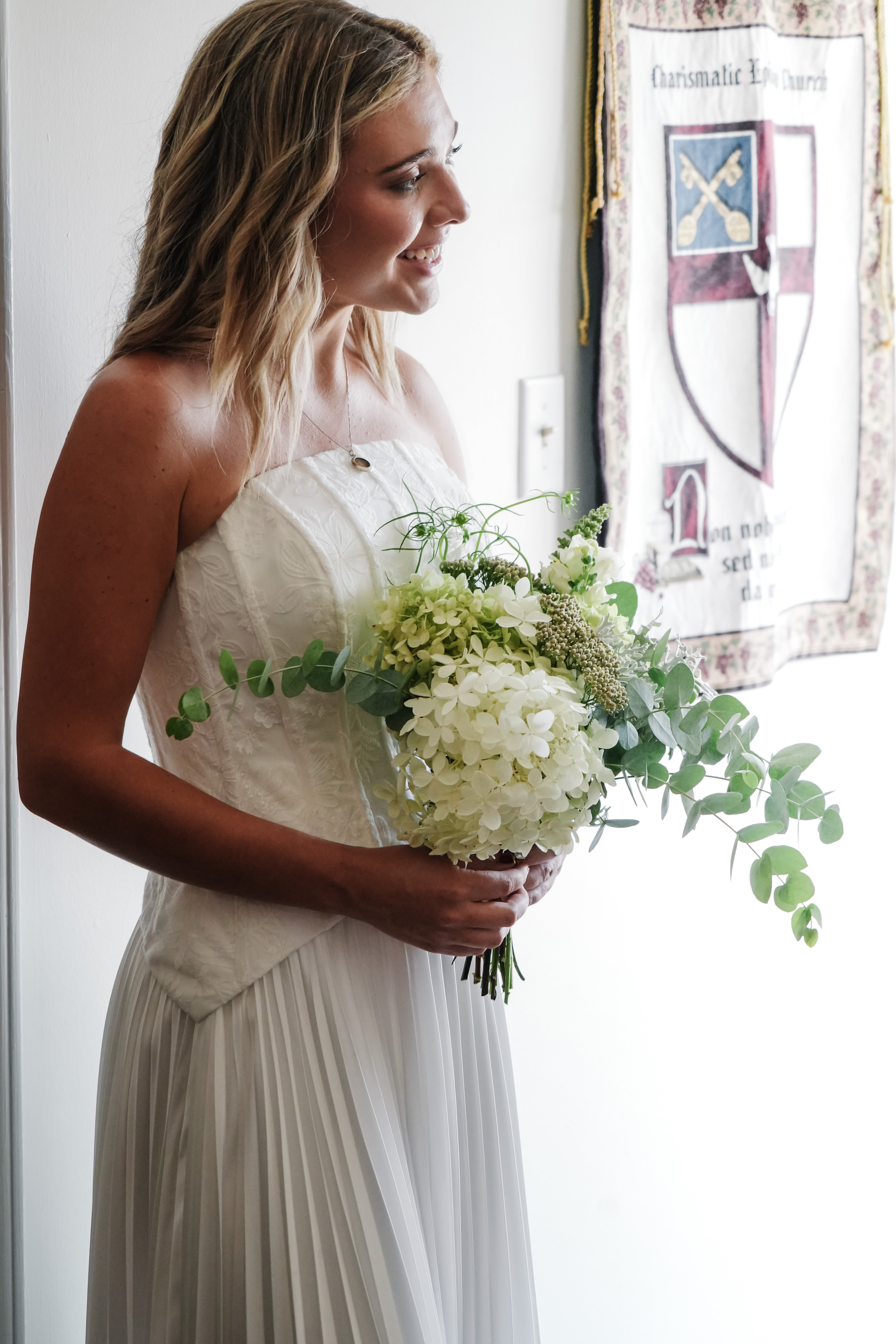 bride standing with a boquet of flowers